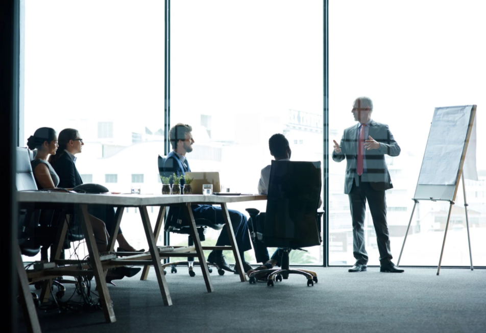 Professionals convening in a modern boardroom for a research discussion